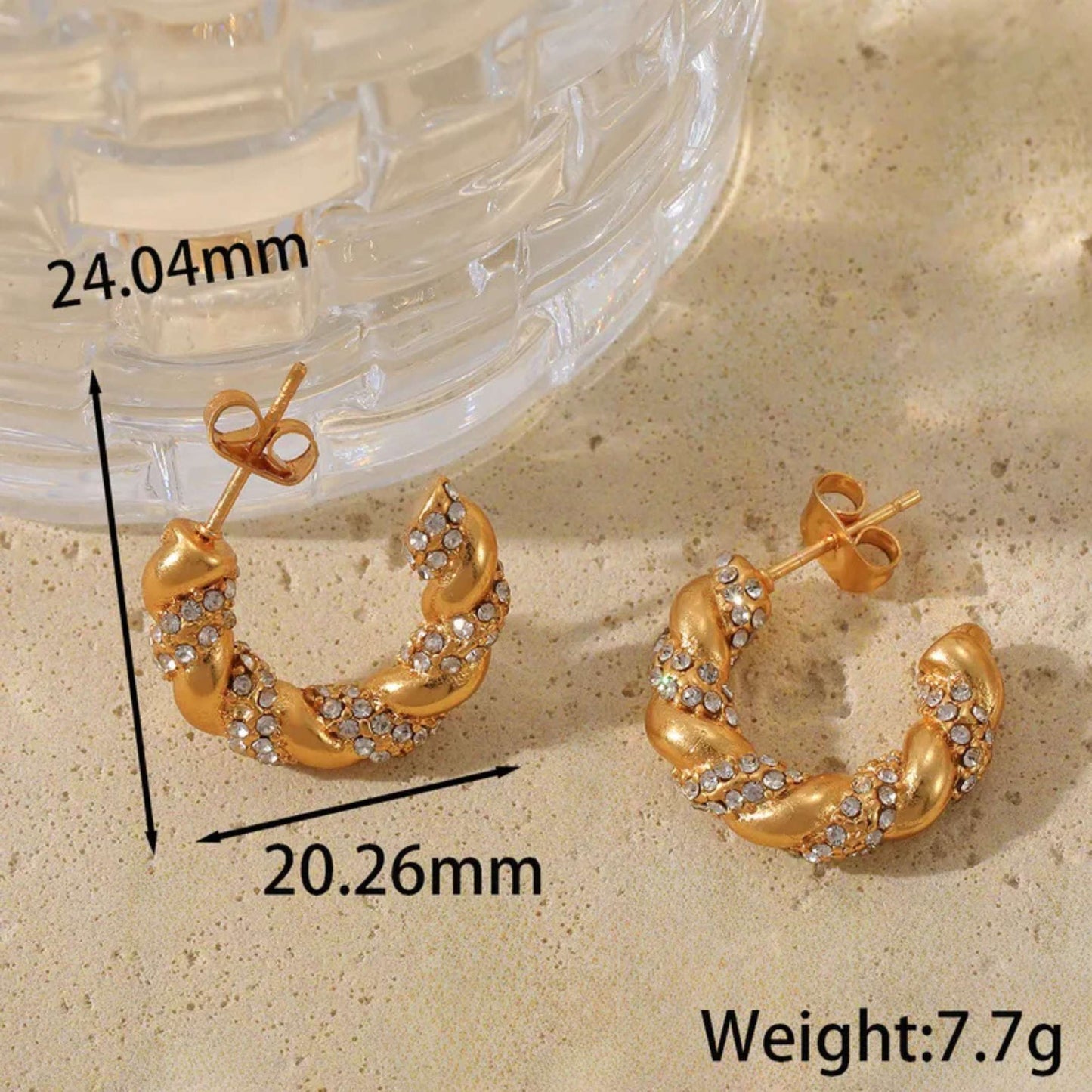 Gold diamond hoop earrings with measurements and weight on a beige surface