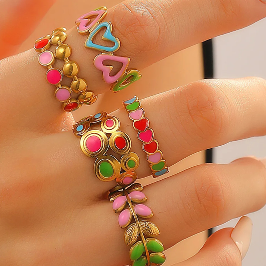 Colorful bracelets on a person's wrist with a neutral background