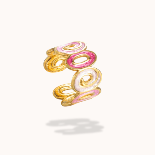 Gold and pink spiral ring on a white background