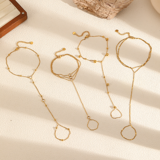 Gold Ring Bracelet on a textured beige surface