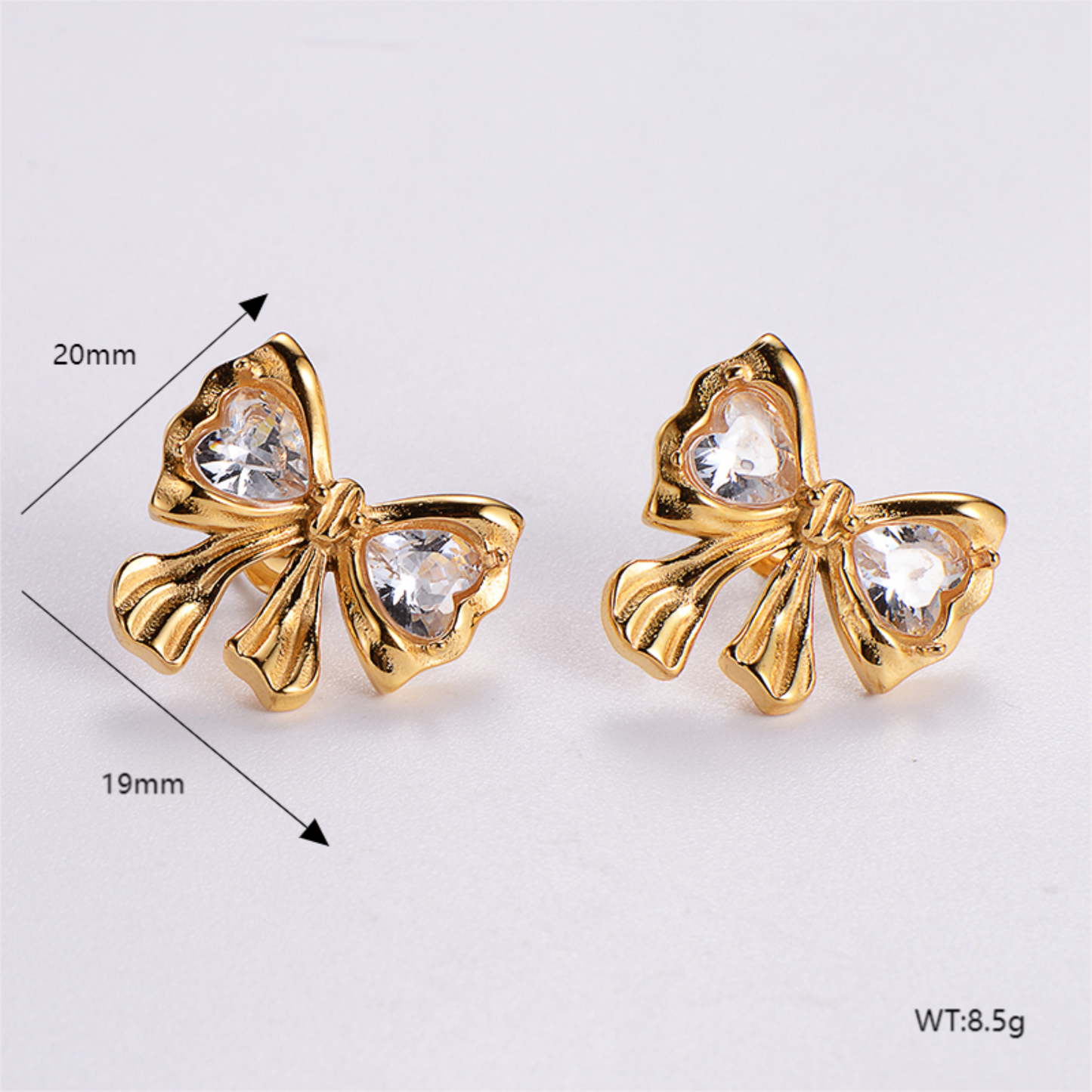 Gold bow-shaped earrings with clear gemstones on a white background, showing measurements and weight.