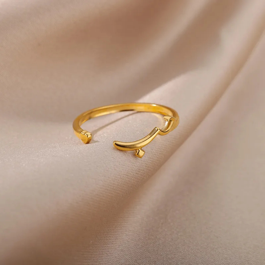 Gold open ring on a beige fabric background