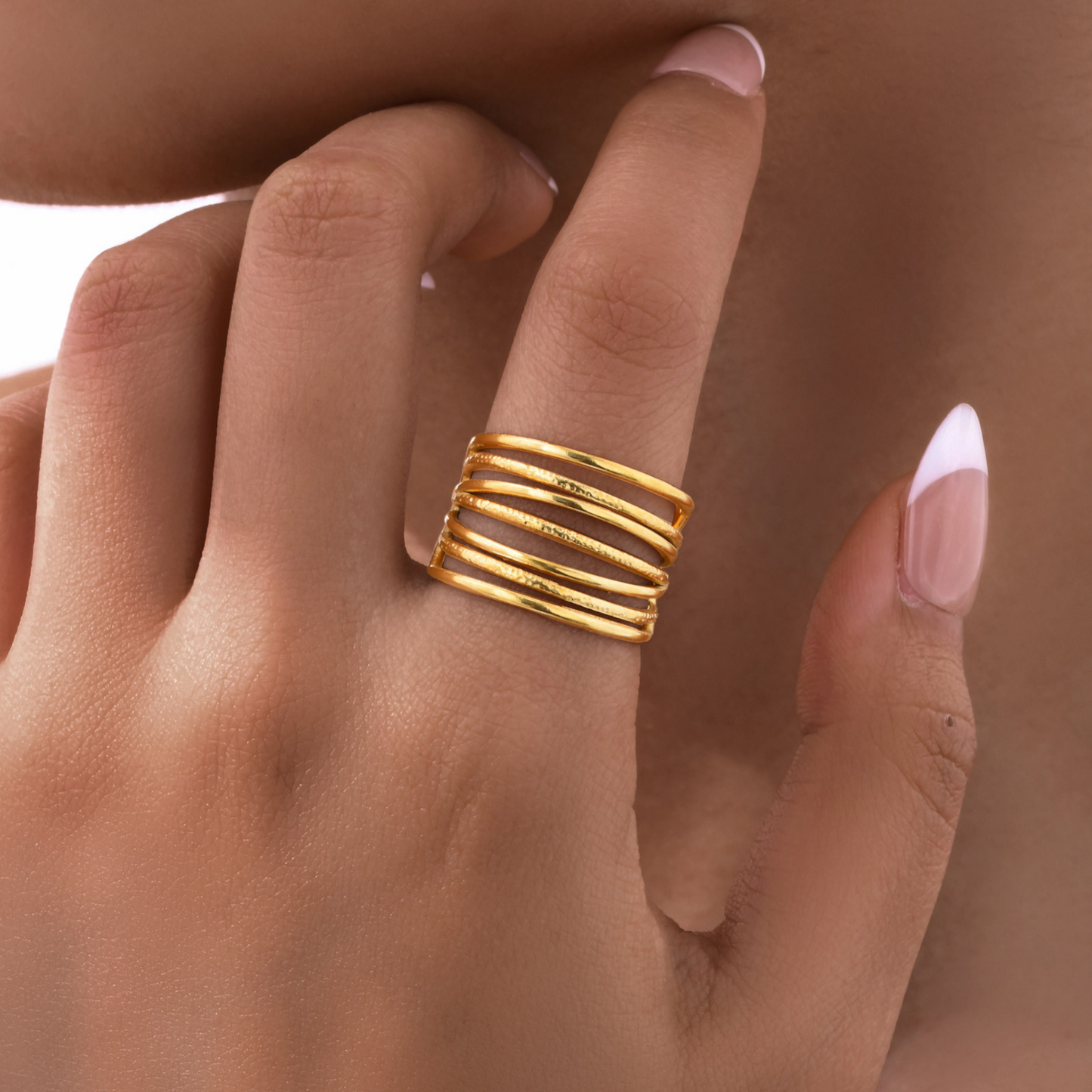 Gold ring on a finger with a blurred background