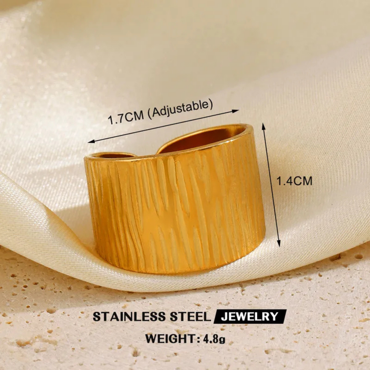 Gold adjustable ring with measurements on a beige fabric background