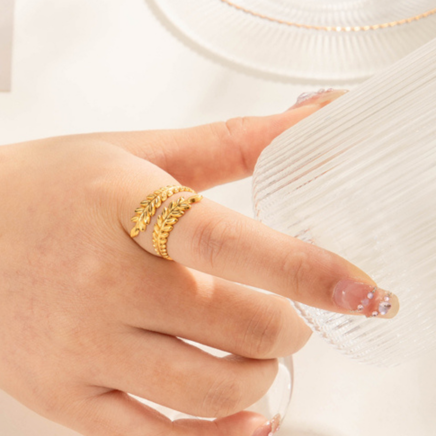 Gold ring on a finger with a white background