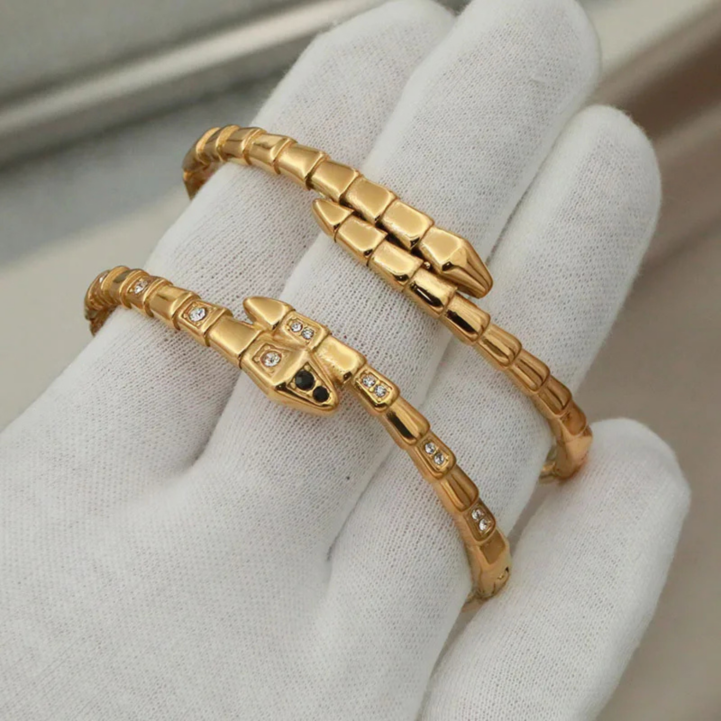 Gold bracelets on a white glove