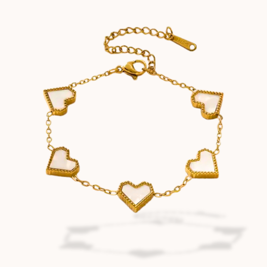 Gold bracelet with heart-shaped charms on a white background