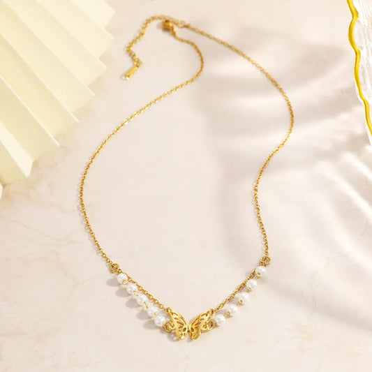 Gold necklace with pearls on a light fabric background