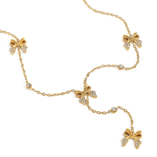 Gold necklace with bow-shaped charms on a white background