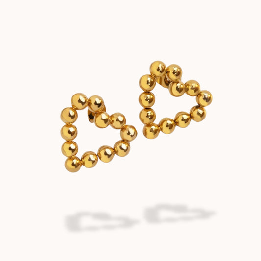 Pair of gold heart beaded earrings on a white background