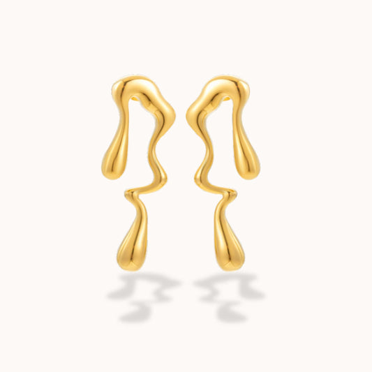 Gold geometric earrings on a white background