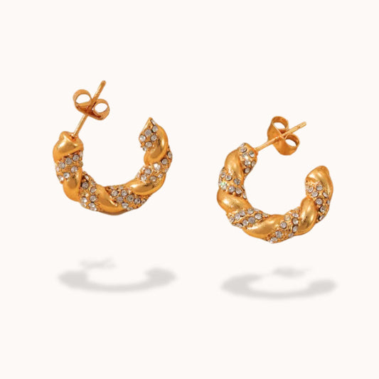 Gold hoop earrings with embedded stones on a white background
