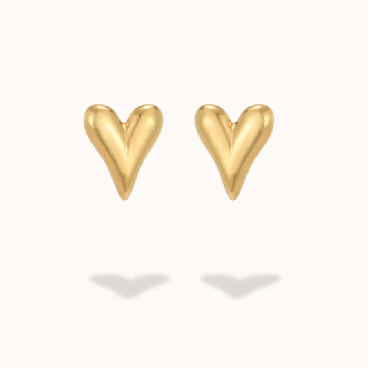 Gold heart-shaped earrings on a white background