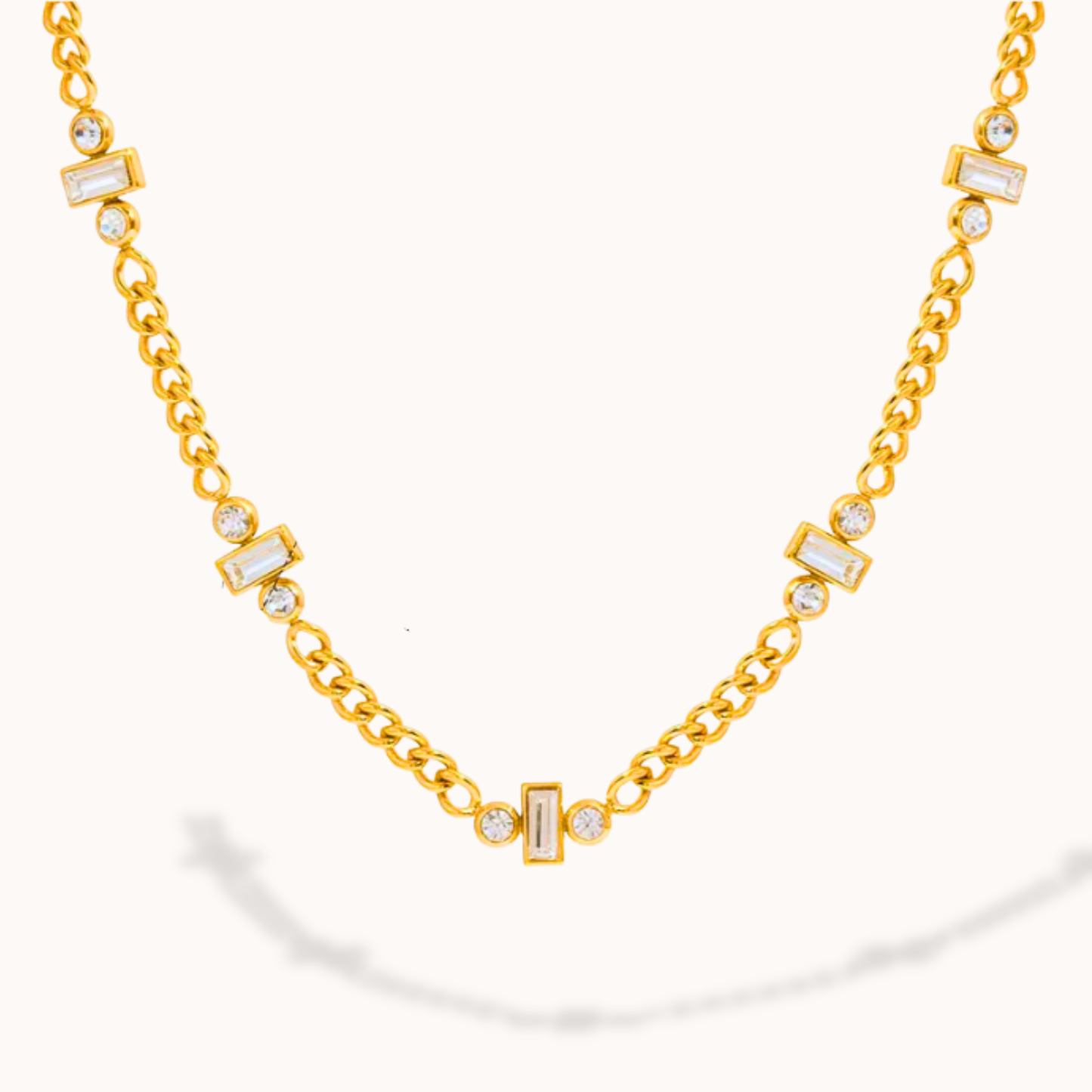 Gold necklace with diamond accents on a white background