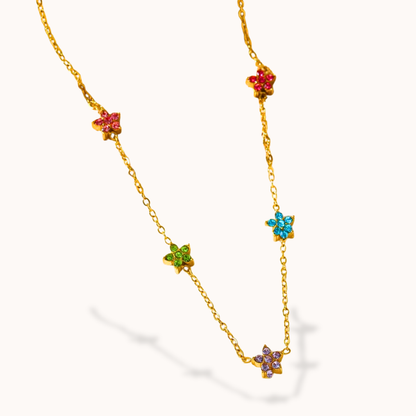 Gold necklace with colorful star-shaped pendants on a white background