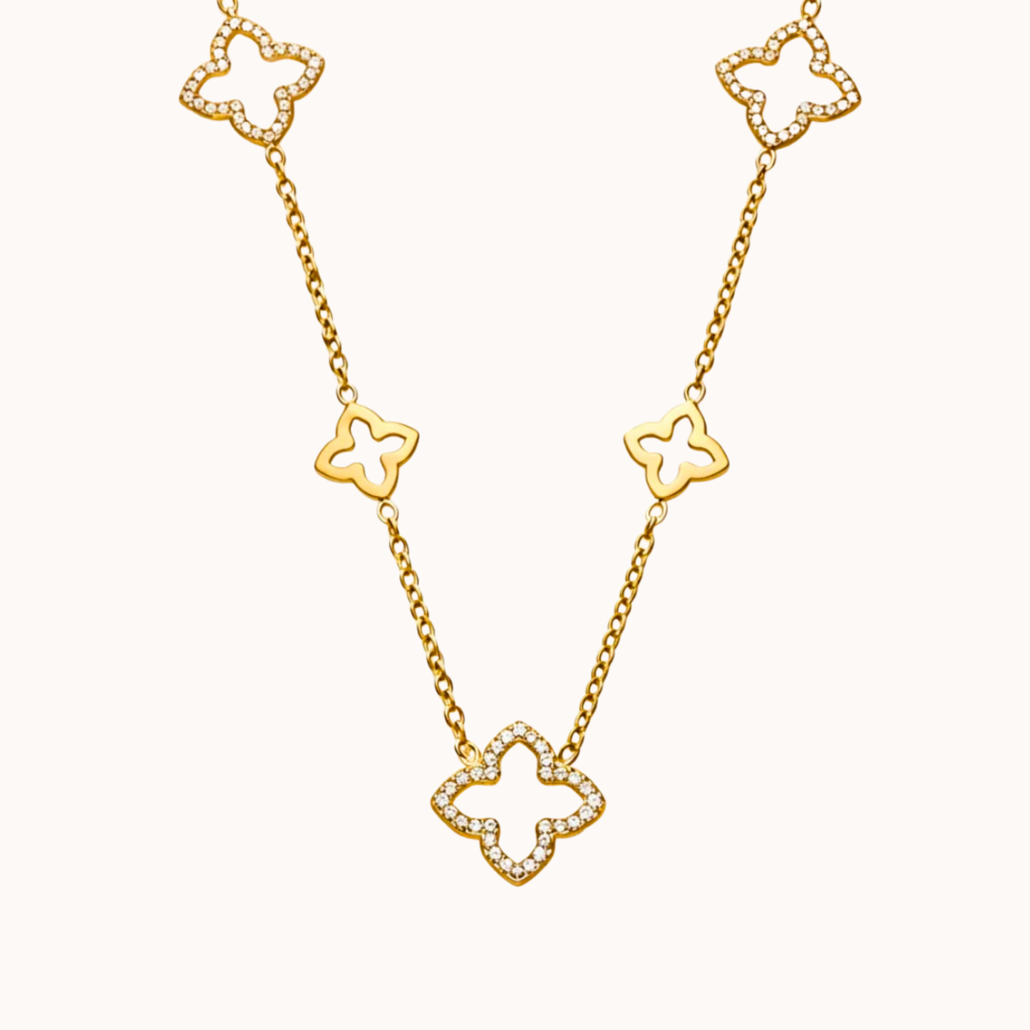 Gold necklace with clover-shaped links on a white background