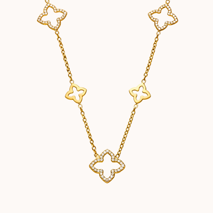 Gold necklace with clover-shaped links on a white background