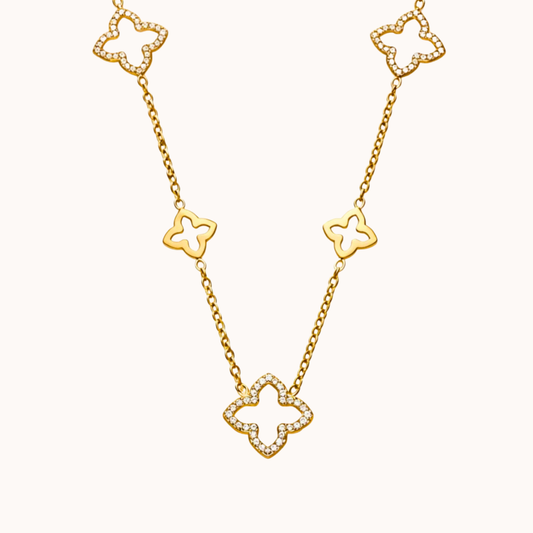 Gold necklace with clover-shaped links on a white background