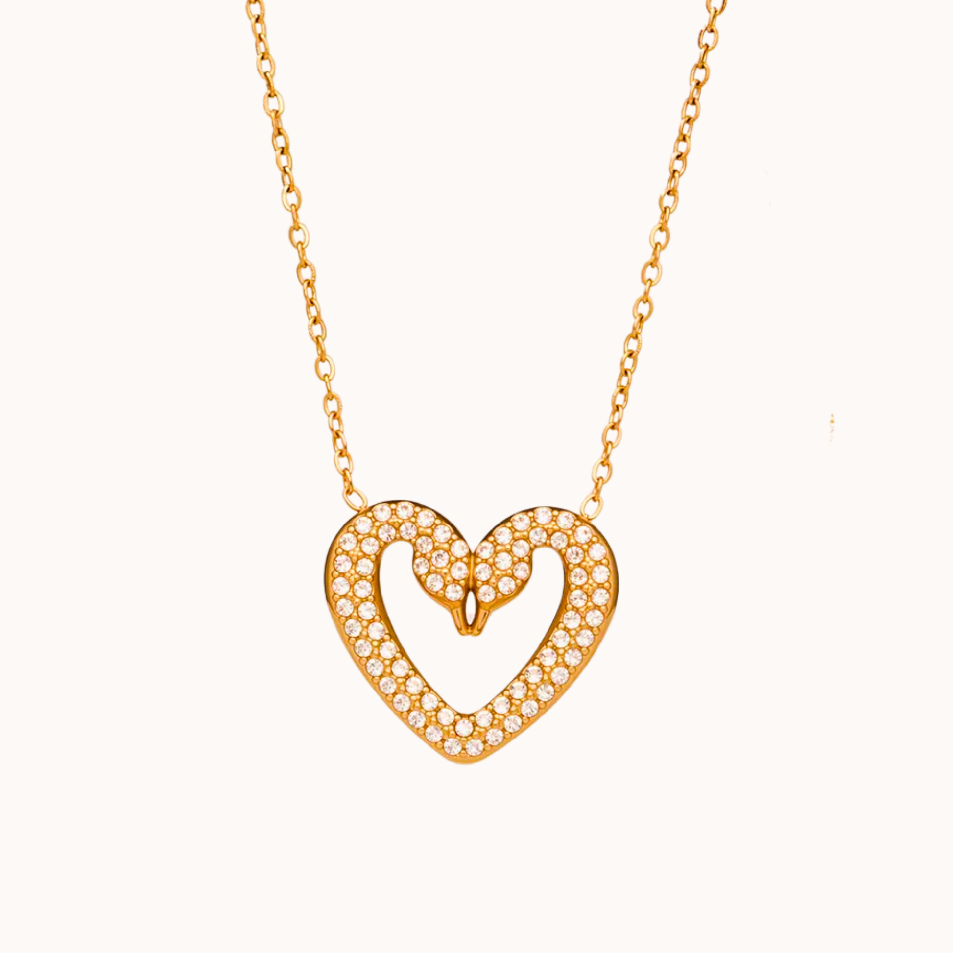 Gold heart-shaped necklace with diamonds on a white background