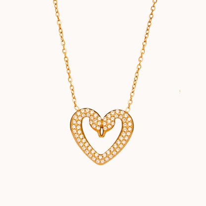 Gold heart-shaped necklace with diamonds on a white background