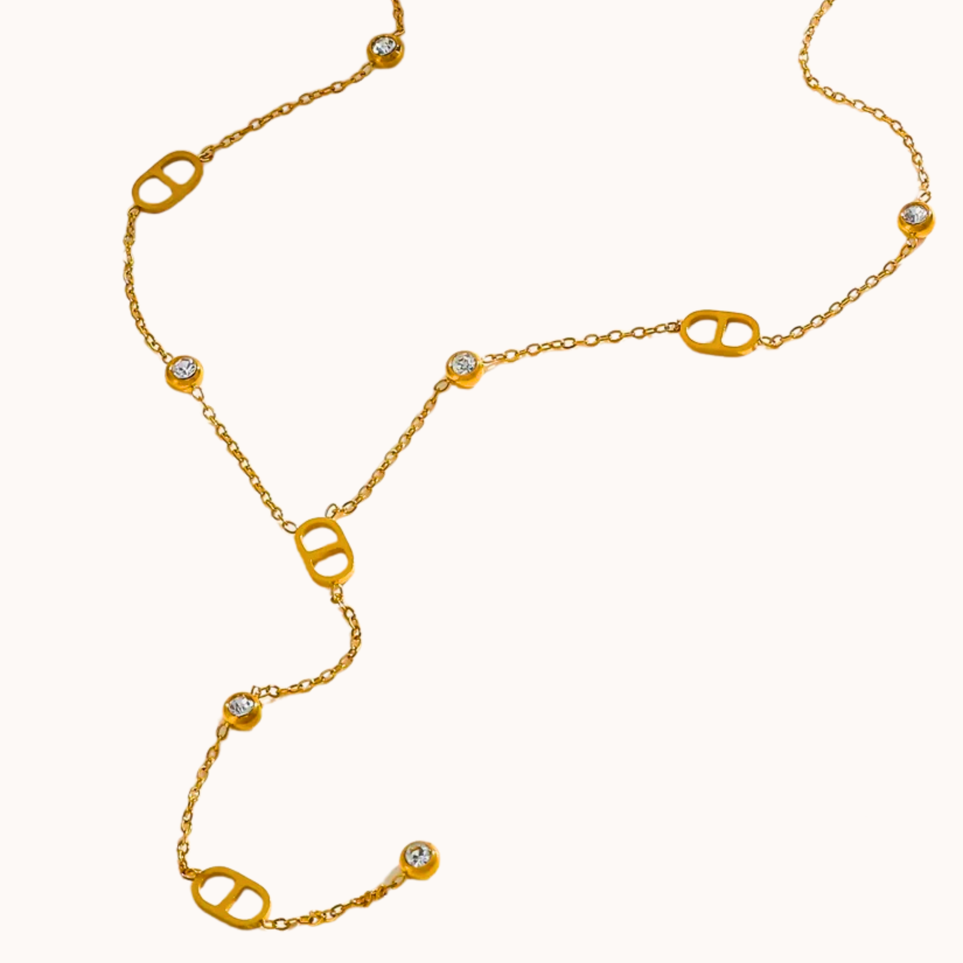 Gold necklace with diamond-like stones on a white background