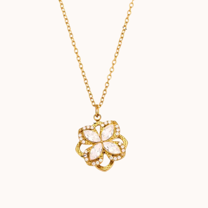 Gold necklace with a floral pendant on a white background