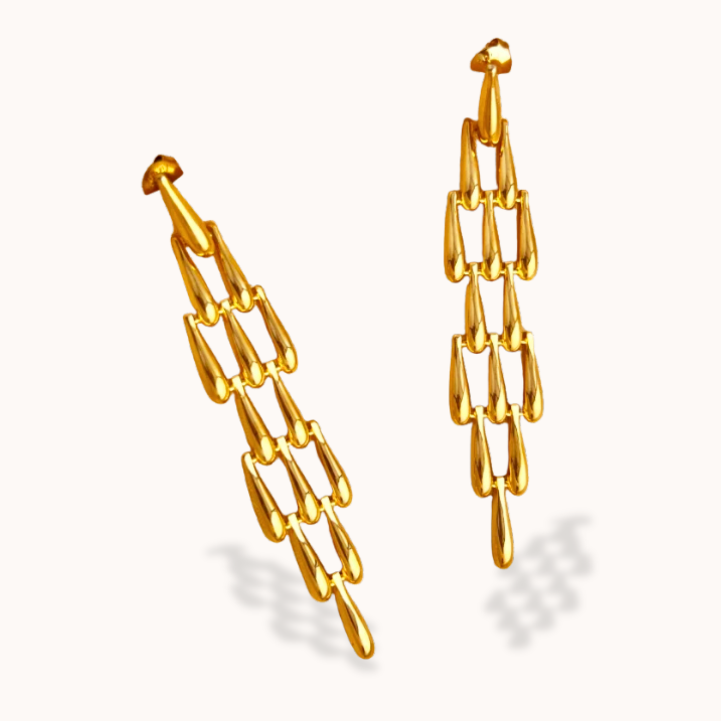 Gold chain earrings on a white background