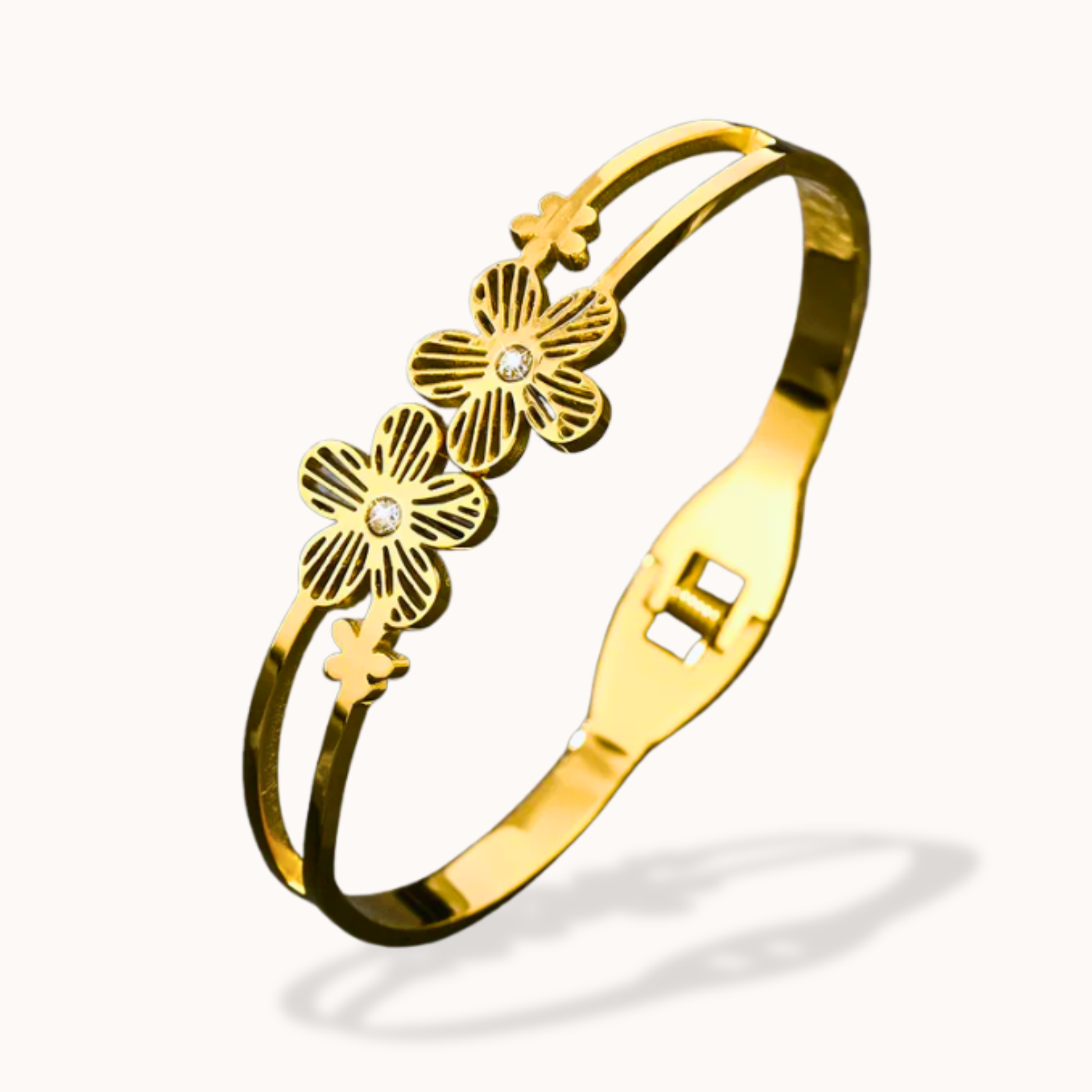 Gold bracelet with floral designs on a white background