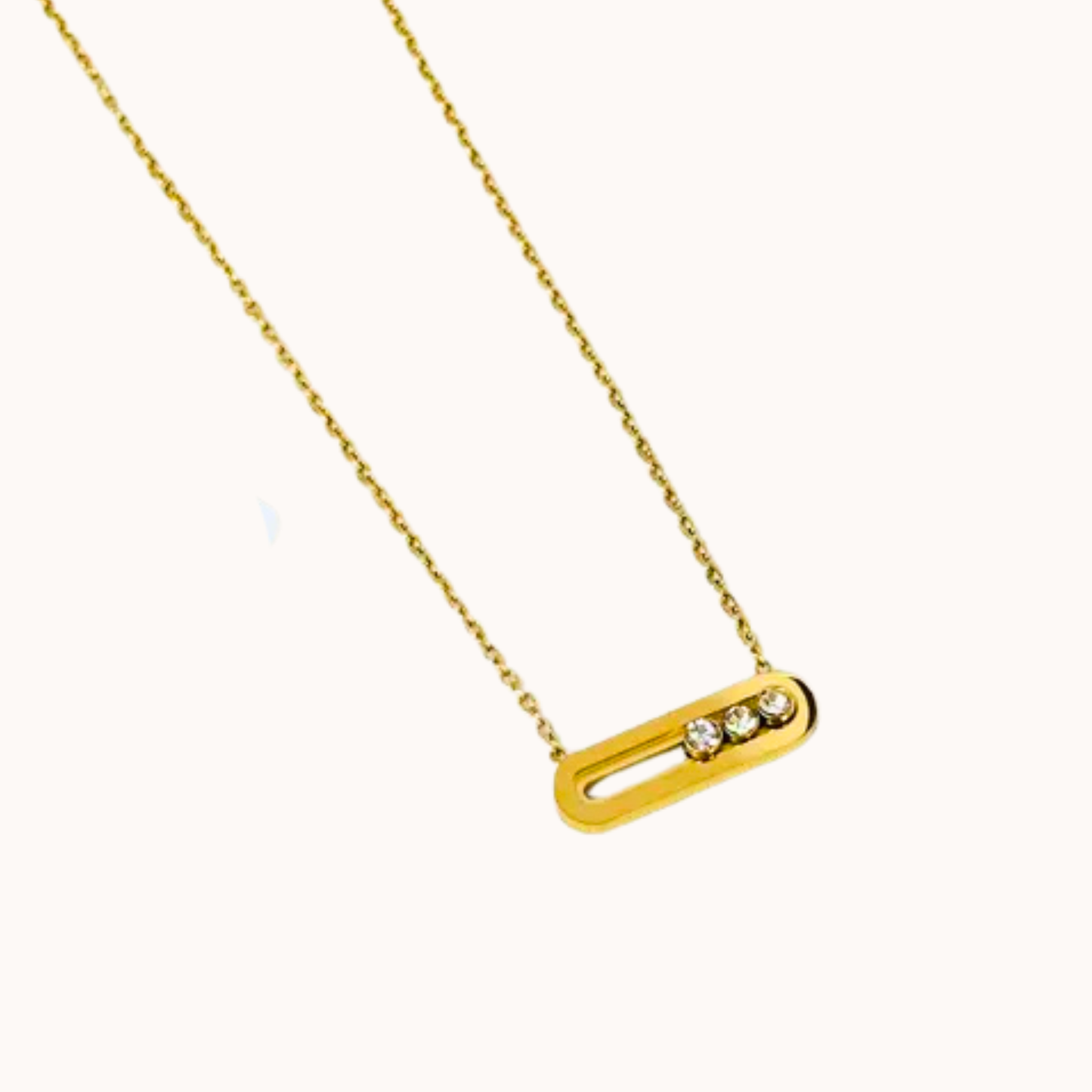 Gold necklace with a bar pendant on a white background