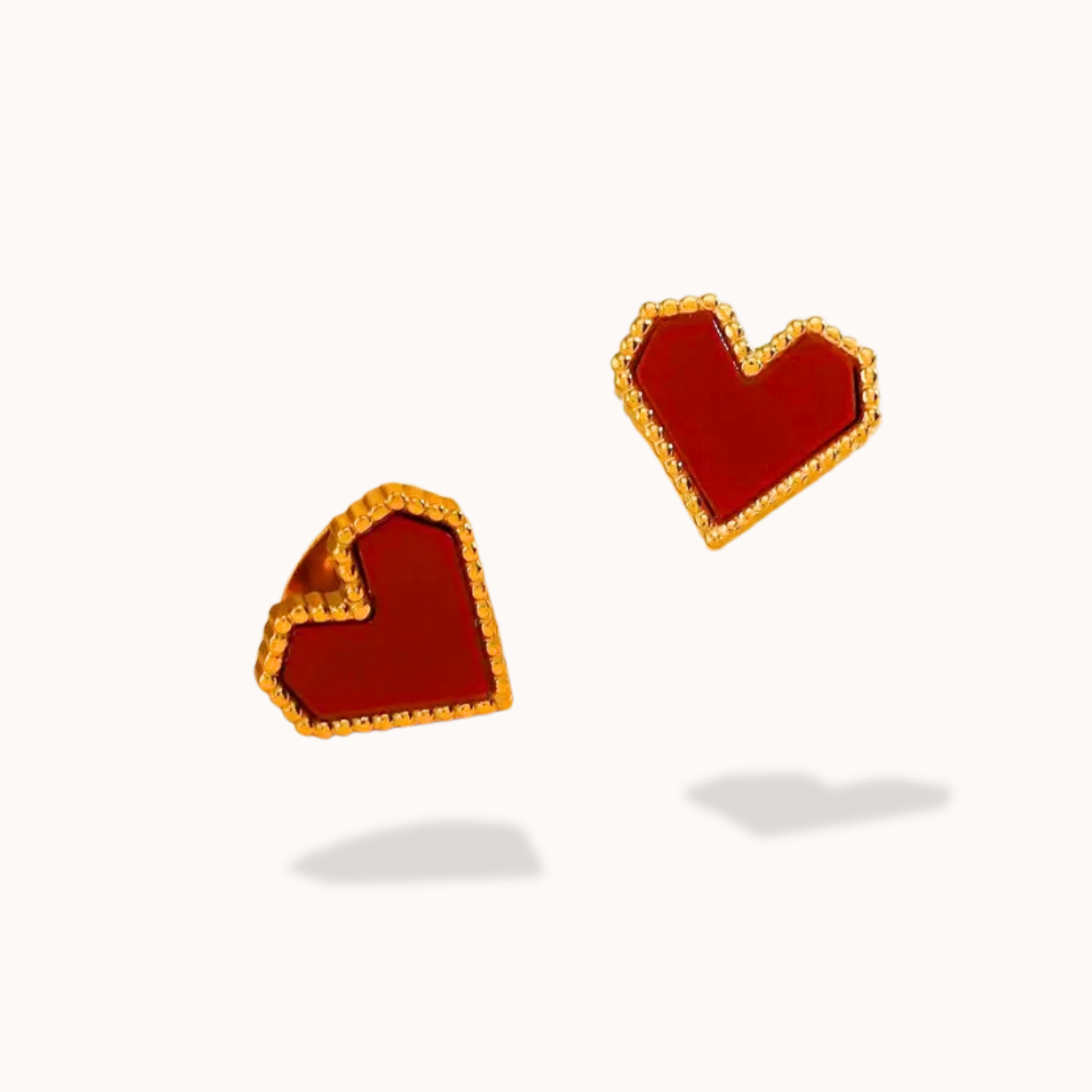 Heart-shaped earrings with gold rims on a white background