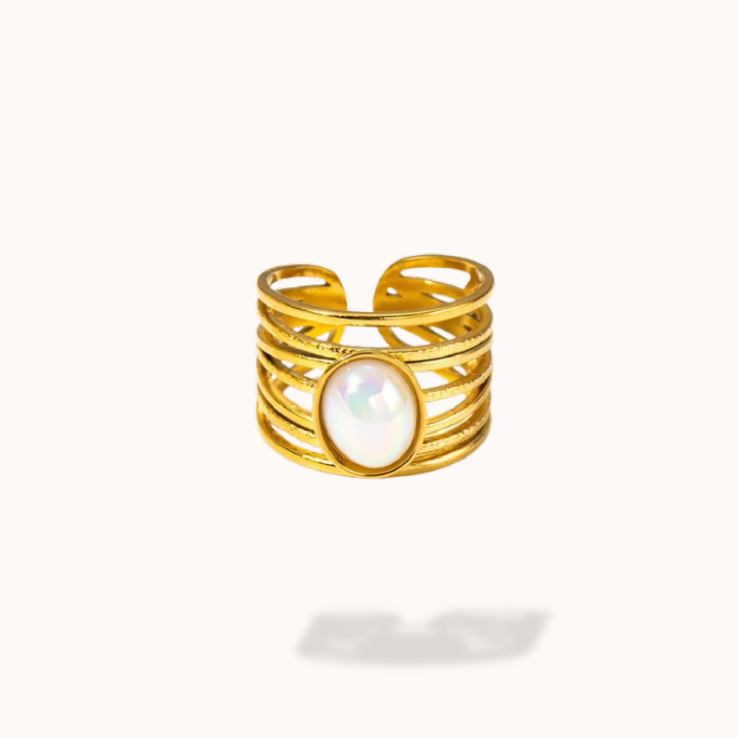 Gold ring with a central pearl on a white background