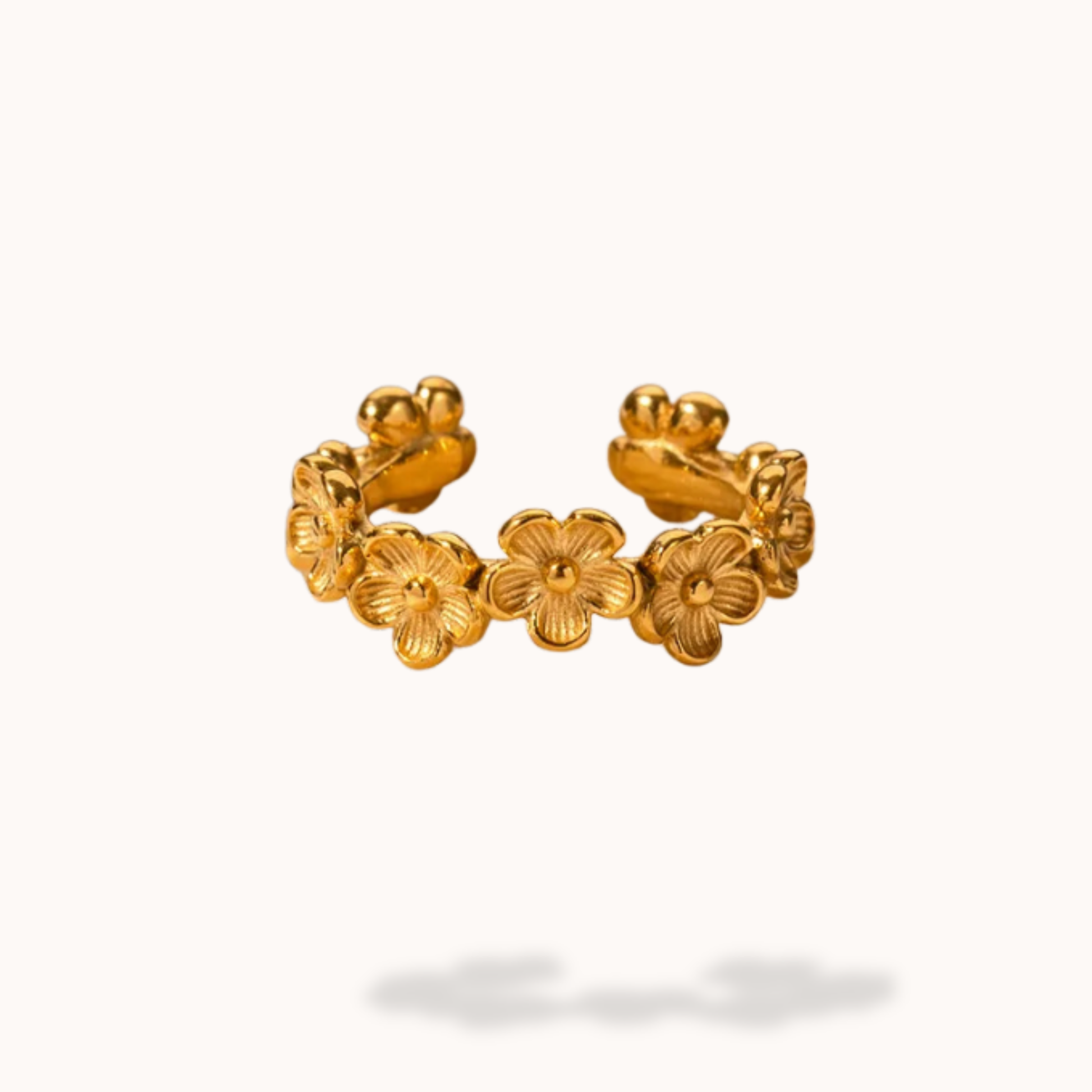 Gold floral ring on a white background