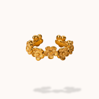Gold floral ring on a white background