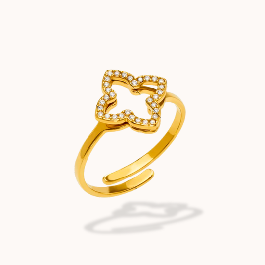 Gold open ring with bow design on a white background