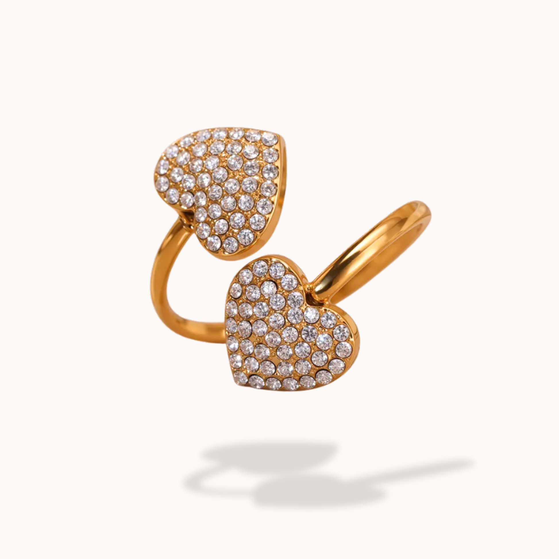 Gold heart-shaped ring with diamond accents on a white background