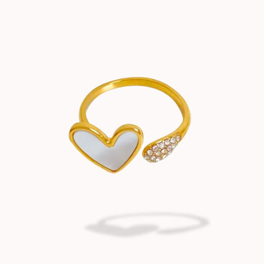 Gold ring with a heart-shaped design on a white background