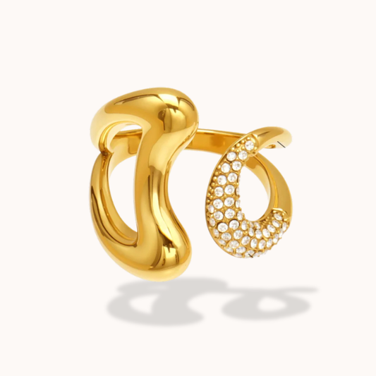 Gold rings with one having embedded stones on a white background