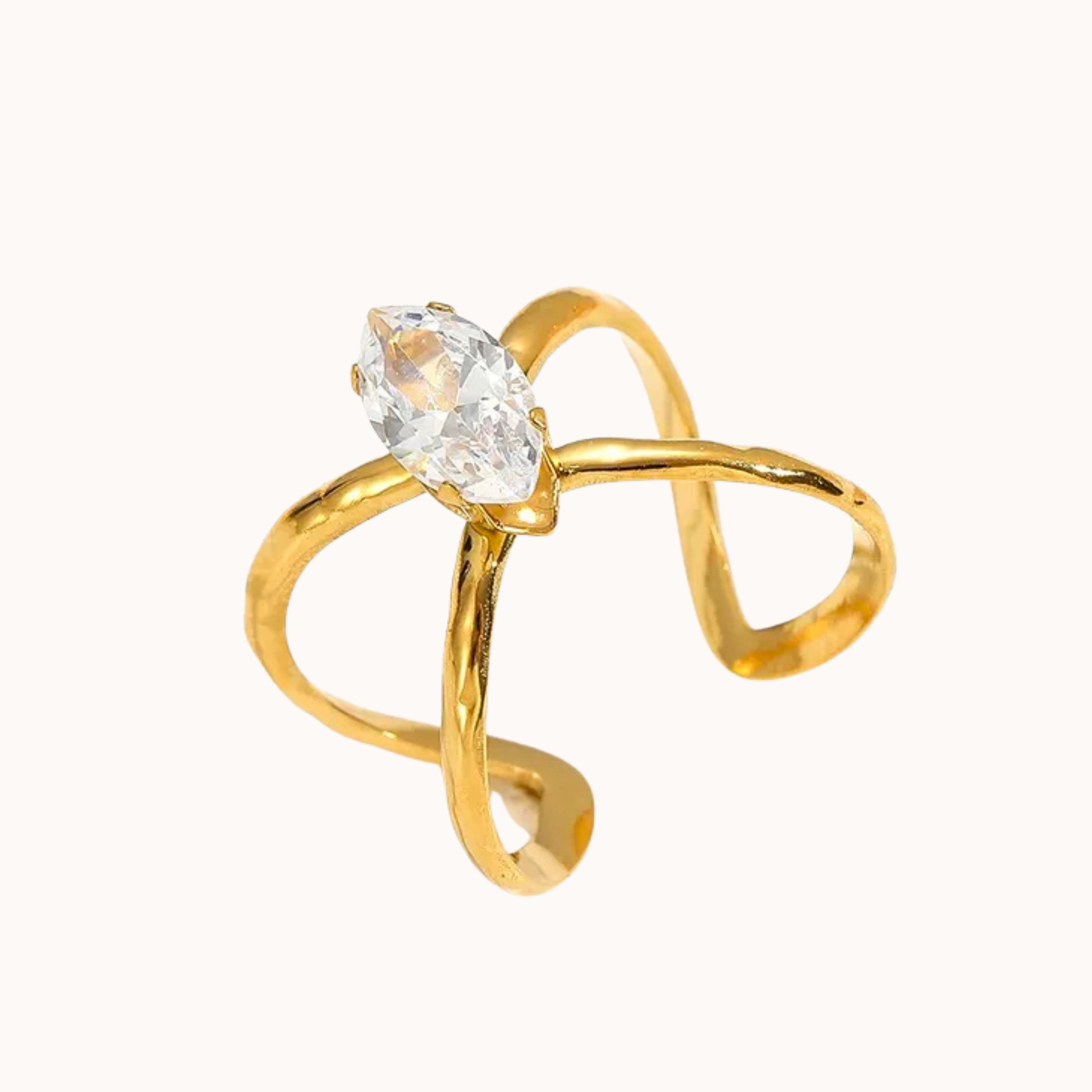 Gold ring with a clear gemstone on a white background