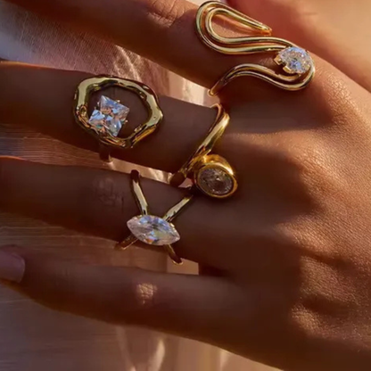Gold rings with gemstones on a hand