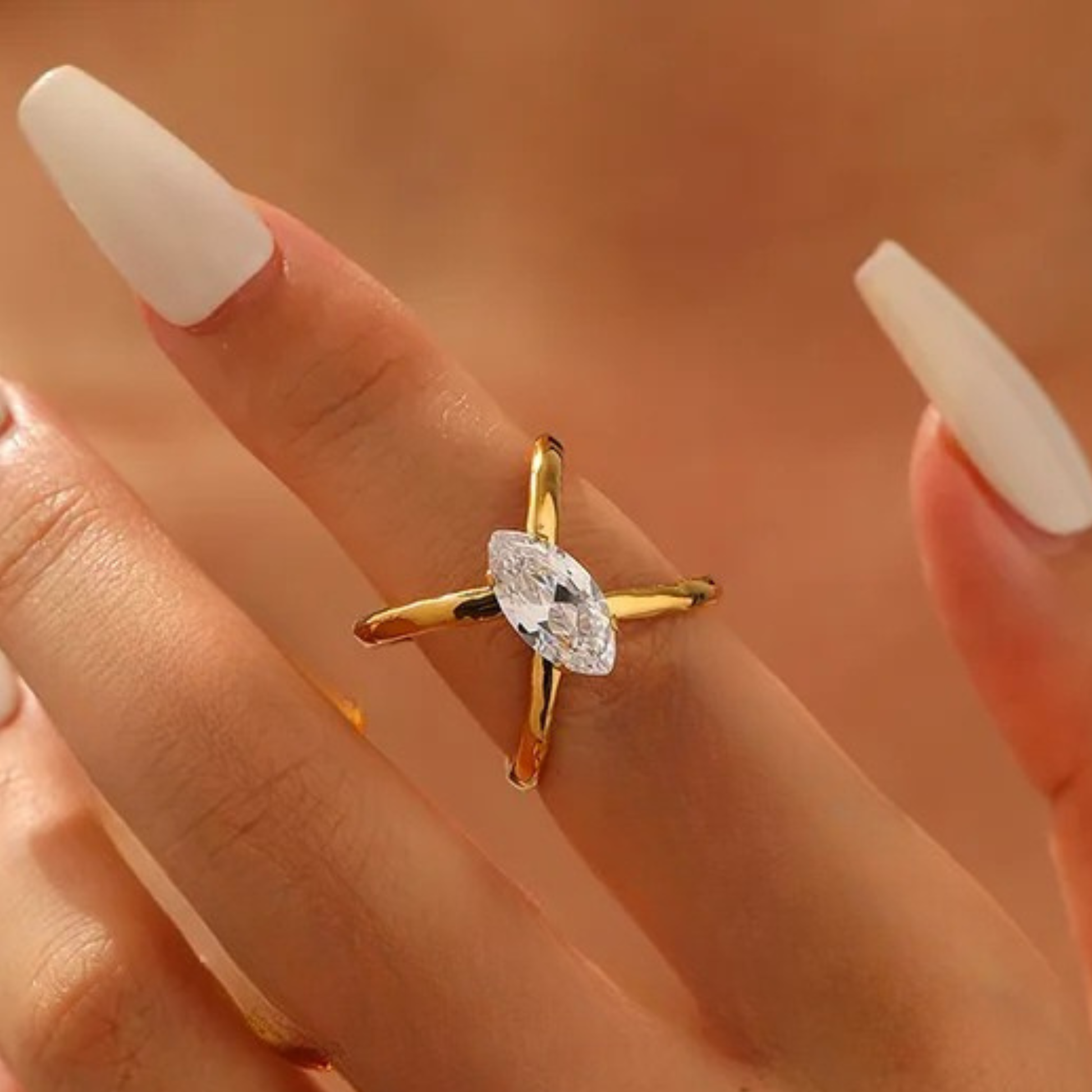 Gold ring with a diamond on a hand against a blurred background