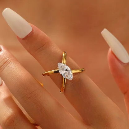 Gold ring with a diamond on a hand against a blurred background