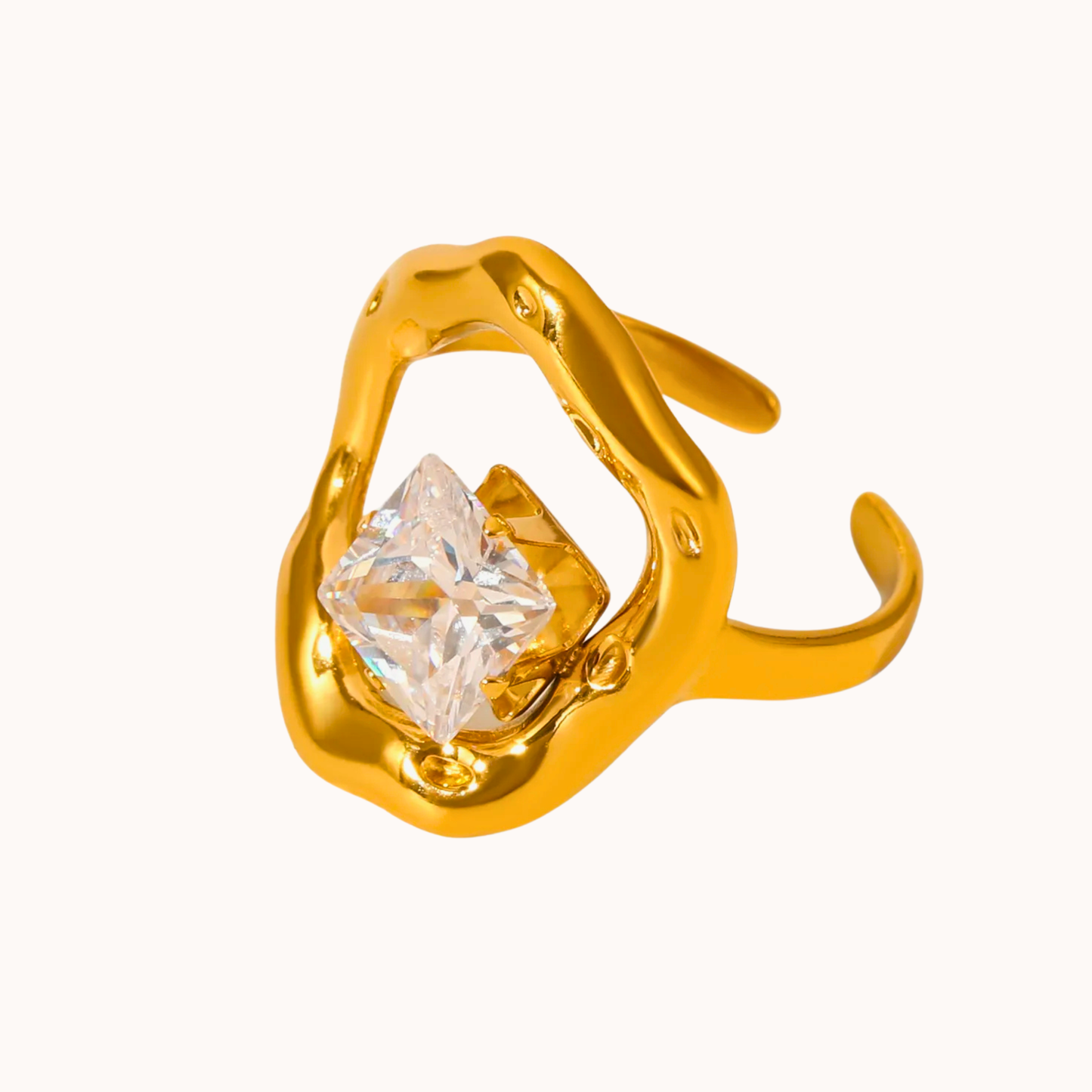 Gold ring with a large diamond on a white background