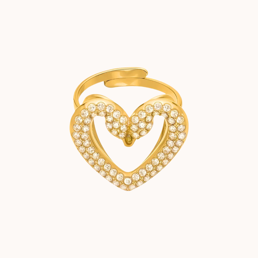 Gold swan heart-shaped ring with embedded stones on a white background
