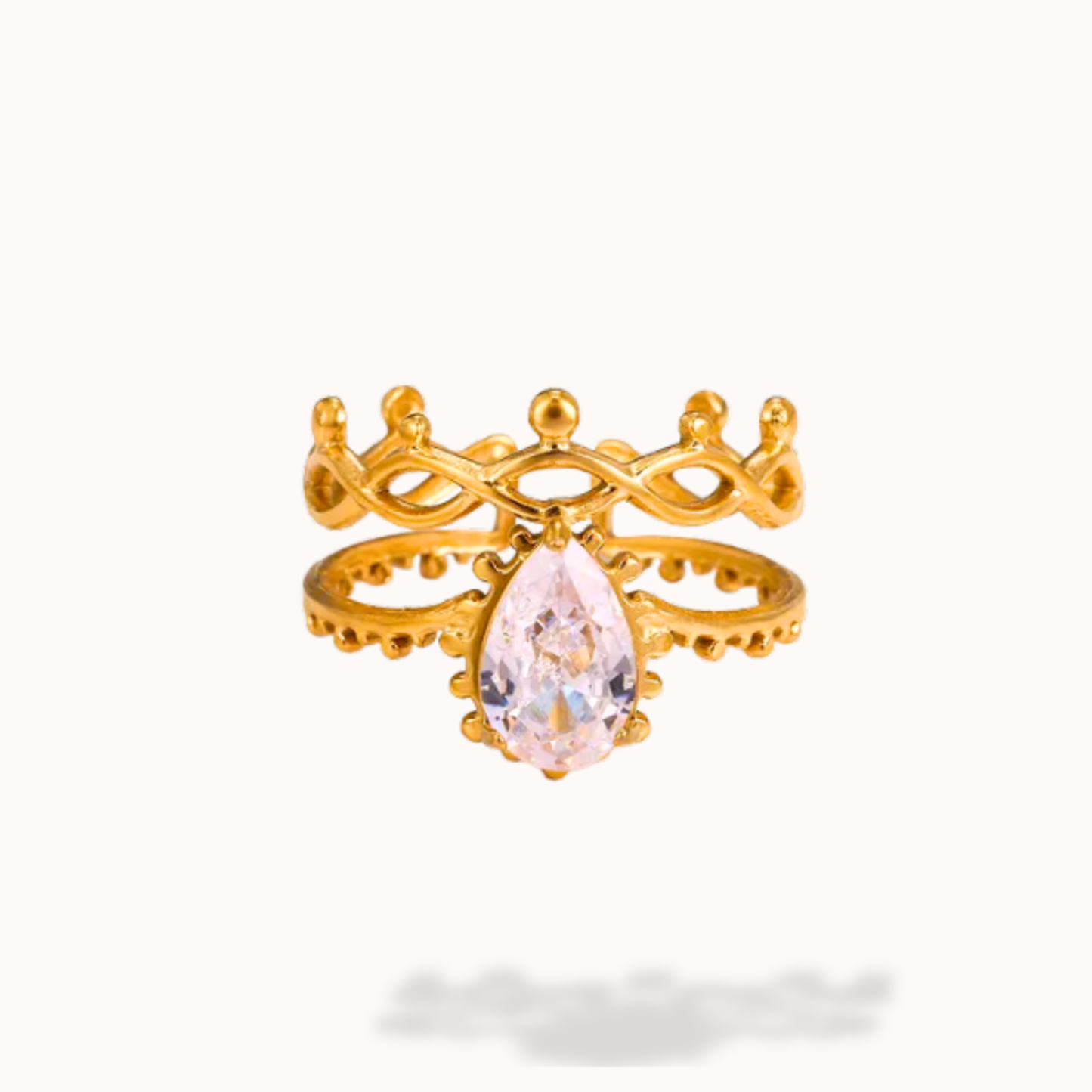 Gold ring with a pink gemstone on a white background