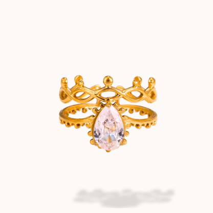 Gold ring with a pink gemstone on a white background
