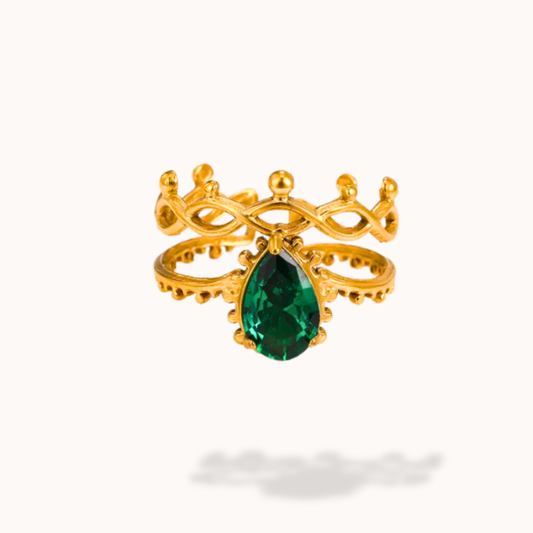 Gold ring with a green gemstone on a white background