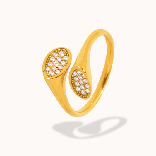 Gold ring with diamond accents on a white background