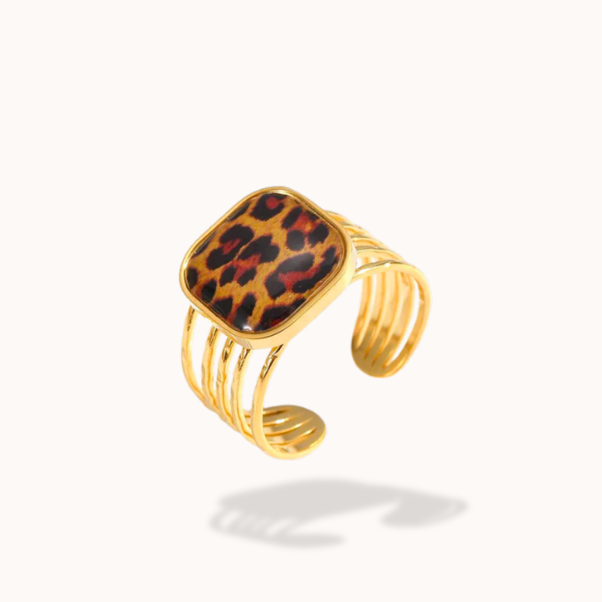 Gold bracelet with a leopard print square charm on a white background