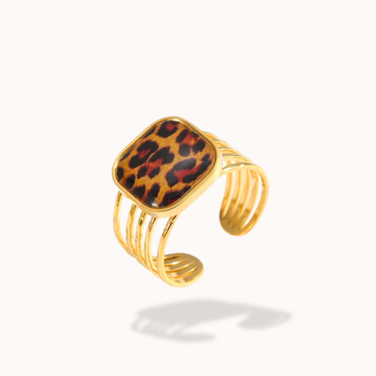 Gold bracelet with a leopard print square charm on a white background