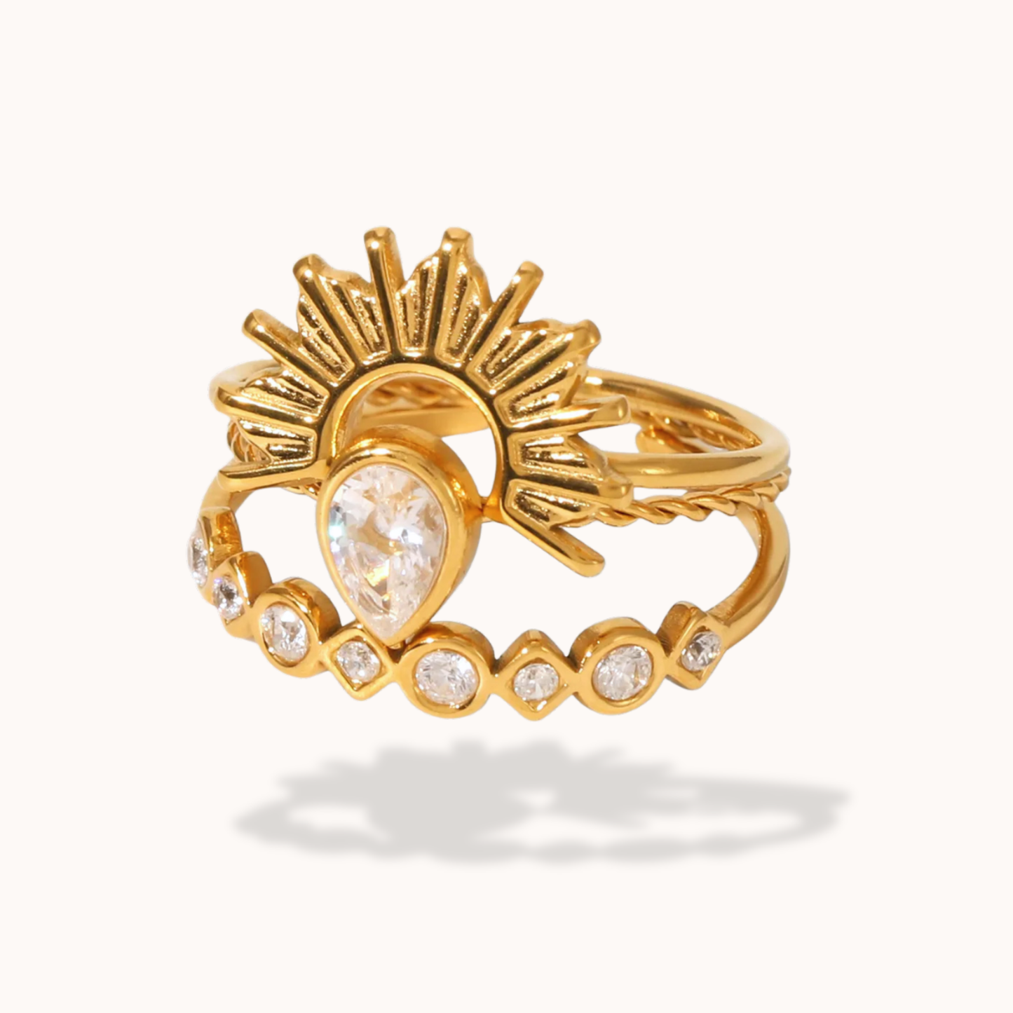 Gold ring with a heart-shaped gemstone on a white background